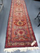 AN ORIENTAL RUNNER OF CAUCASIAN DESIGN. 315x90cms.