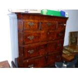 AN INLAID WALNUT EARLY GEORGIAN AND LATER SIX DRAWER HIGH CHEST ON A ONE DRAWER BASE WITH SHAPED