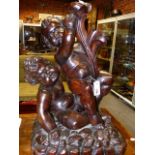 AN EARLY CARVED OAK FIGURAL GROUP OF TWO PLAYFUL PUTTI. H.62cms.
