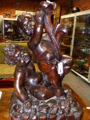 AN EARLY CARVED OAK FIGURAL GROUP OF TWO PLAYFUL PUTTI. H.62cms.