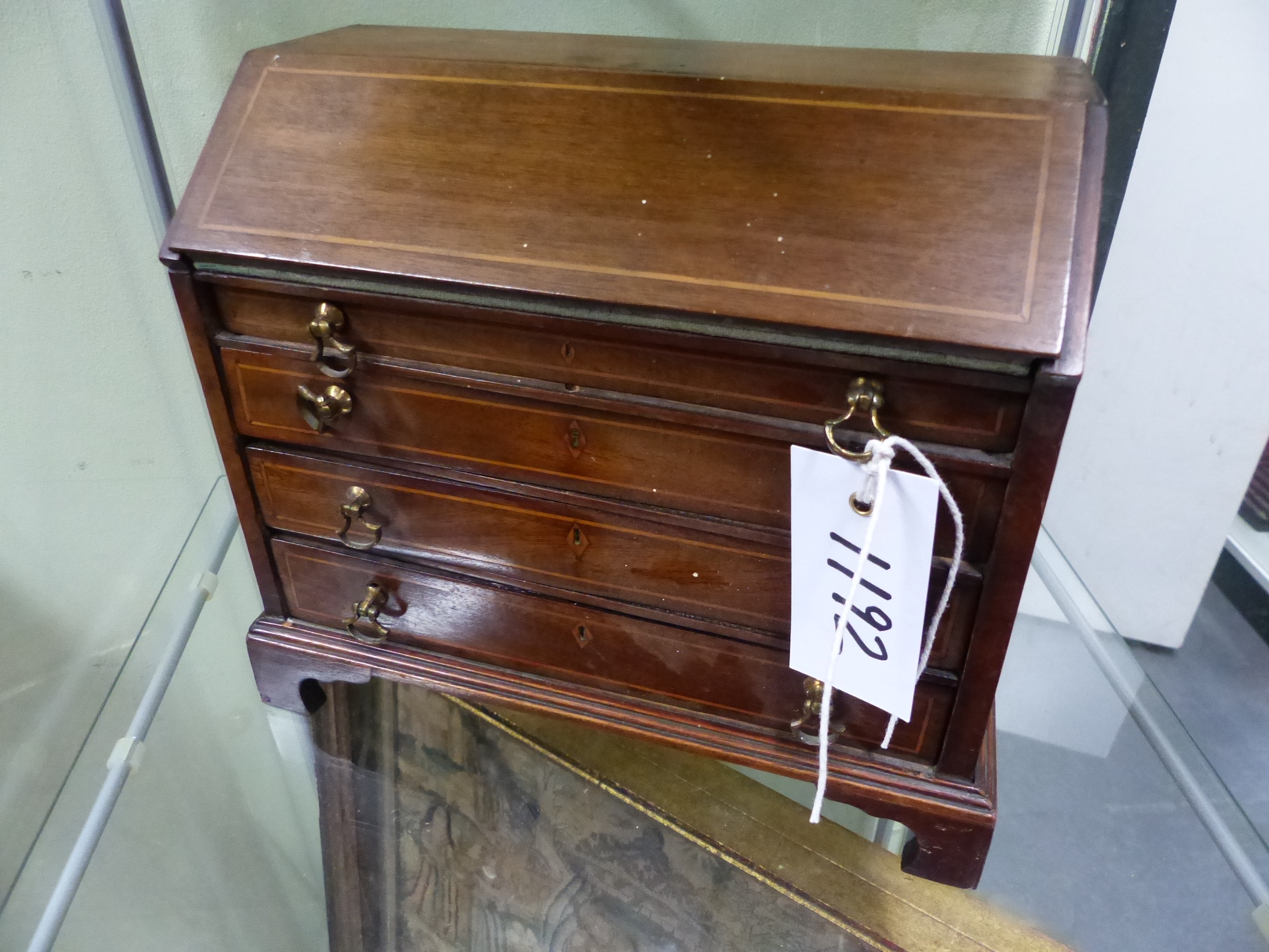 A GEORGIAN AND LATER MINIATURE MAHOGANY SLANT TOP INLAID BUREAU, FITED INTERIOR ABOVE LONG DRAWERS