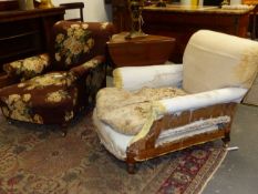 A PAIR OF ANTIQUE HOWARD & SONS UPHOLSTERED CLUB DEEP SEAT ARMCHAIRS, ALL BRASS CASTORS STAMPED