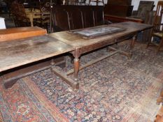 AN 18th.C.AND LATER OAK REFECTORY TABLE WITH DRAW LEAF PLANK TOP OVER TURNED LEGS UNITED BY