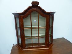 A SMALL WALNUT WALL MOUNTED DISPLAY CABINET IN THE DUTCH MANNER. H.68cms.