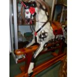 AN EARLY 20th.C.CARVED AND PAINTED WOOD ROCKING HORSE ON TRESTLE BASE. 92cms (HOOF TO EAR)