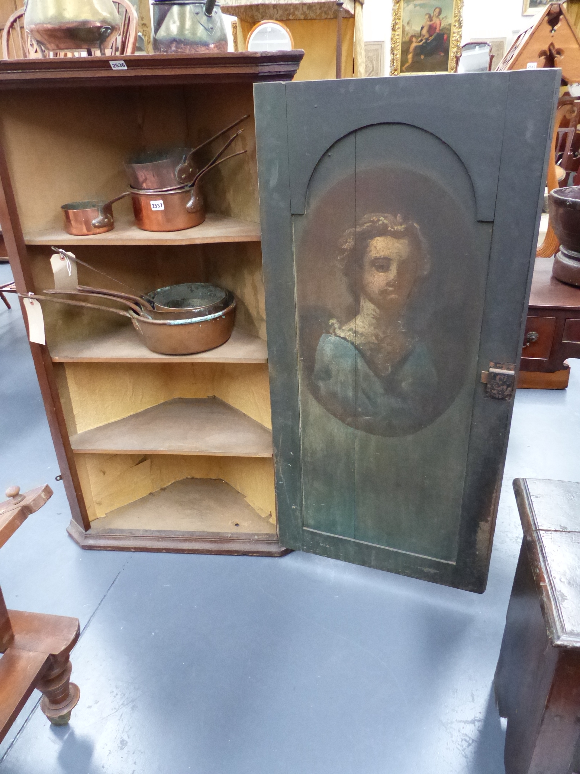 A 19th.C.OAK WALL HANGING CORNER CABINET THE INTERIOR WITH PAINTED PORTRAIT STUDY OF A YOUNG GIRL.