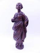 AN EARLY ANTIQUE CARVED OAK FIGURE OF A STANDING FEMALE SAINT. H.29cms.