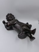 AN ANTIQUE CARVED OAK FIGURE OF A CHILD WITH UPRAISED ARMS. H.43cms.