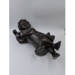 AN ANTIQUE CARVED OAK FIGURE OF A CHILD WITH UPRAISED ARMS. H.43cms.