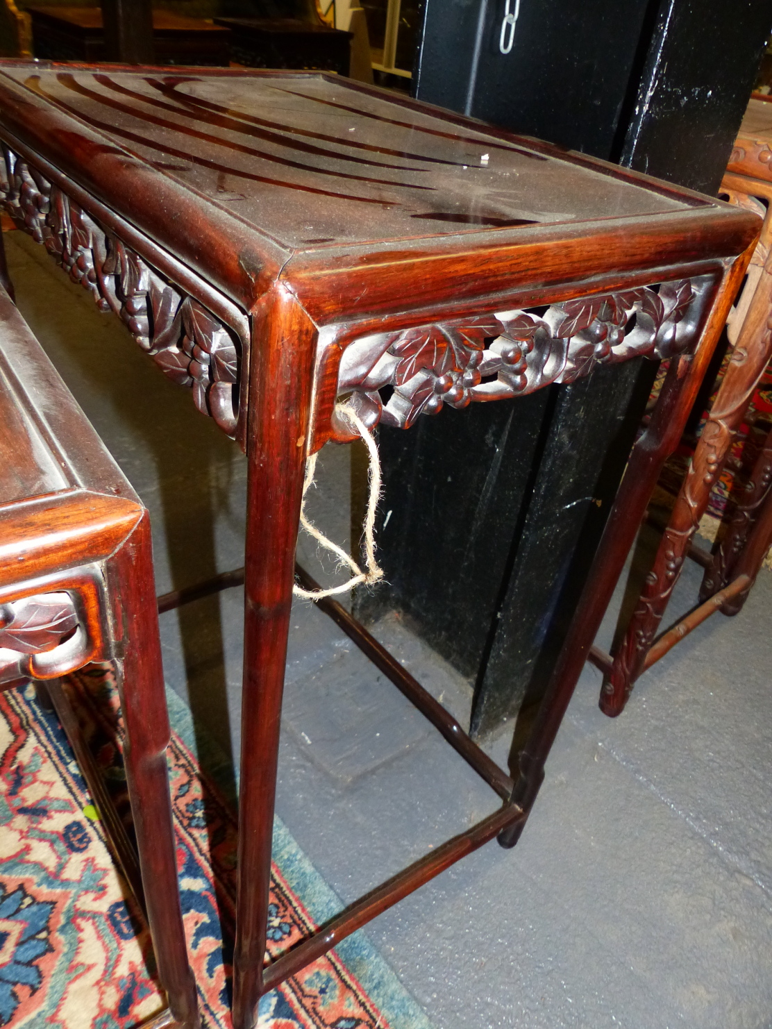 A NEST OF FOUR CHINESE CARVED HARDWOOD TABLES WITH PIERCED FOLIATE APRONS. - Image 10 of 19