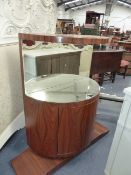 AN UNUSUAL ROSEWOOD MIRROR BACK SIDE CABINET OF BOWED FORM IN THE ART DECO TASTE. H.106 x W.106 x