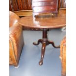 A GEORGIAN MAHOGANY BIRDCAGE TILT TOP TABLE WITH GUNBARREL TAPERED PEDESTAL AND TRIFID SCROLL LEGS