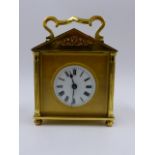 A SMALL EARLY 20th.C.BRASS CASED CARRIAGE CLOCK WITH TWIN ESCARPMENT WINDOW TO PEDIMENT TOP,