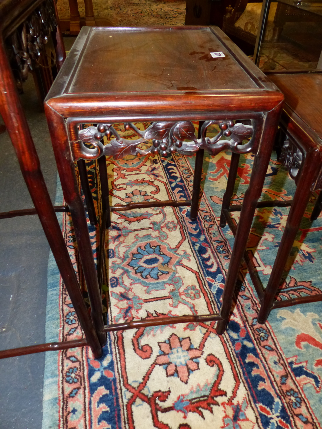 A NEST OF FOUR CHINESE CARVED HARDWOOD TABLES WITH PIERCED FOLIATE APRONS. - Image 4 of 19