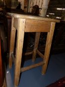 AN ANTIQUE RUSTIC PINE AND SYCAMORE STOOL.