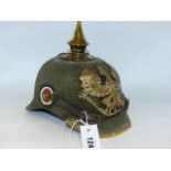 A GERMAN PICKLEHAUBE HELMET WITH GREEN CLOTH SKULL AND SPIKE FINIAL.