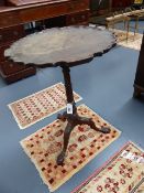 AN ANTIQUE MAHOGANY PIE CRUST TRIPOD TABLE WITH CARVED LEGS AND CLAW AND BALL FEET. D.52cms.