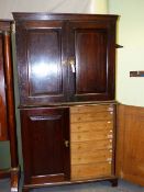 AN 18th.C.ENGLISH OAK TWO PART CABINET WITH PANELLED DOOR UPPER SECTION ENCLOSING SHELVES, THE LOWER