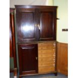 AN 18th.C.ENGLISH OAK TWO PART CABINET WITH PANELLED DOOR UPPER SECTION ENCLOSING SHELVES, THE LOWER