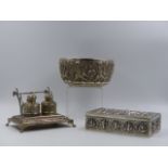 A WHITE METAL INDIAN EMBOSSED CIGARETTE BOX AND BOWL TOGETHER WITH A TWO BOTTLE INKSTAND.