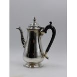A SILVER HALLMARKED COFFEE POT WITH AN EBONY HANDLE 1927 LONDON, APPROXIMATE HEIGHT 20.5cms,