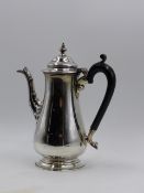 A SILVER HALLMARKED COFFEE POT WITH AN EBONY HANDLE 1927 LONDON, APPROXIMATE HEIGHT 20.5cms,