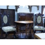 AN UNUSUAL PAIR OF CARVED WALNUT HALL CHAIRS WITH LION HEAD FINIALS TOGETHER WITH A VICTORIAN