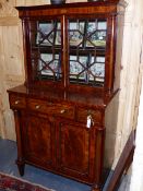 AN INLAID MAHOGANY REGENCY AND LATER CABINET WITH ASTRAGAL GLAZED UPPER SECTION FLANKED BY COLUMN