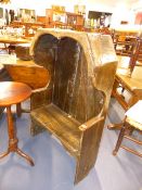 AN ANTIQUE OAK CHILD'S HOODED HALL SETTLE. W.59 x H.114cms.