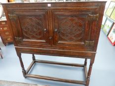 A 17th/18th.C.OAK TWO DOOR FOOD CUPBOARD ON STAND WITH PIERCED PANEL DOORS. W.114 x H.125cms.