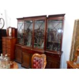 A MAHOGANY GEORGIAN AND LATER ASTRAGAL GLAZED FOUR DOOR BREAKFRONT BOOKCASE WITH DENTIL CORNICE,