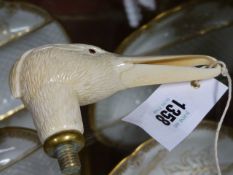 A WELL CARVED 19th.C.IVORY HANDLE MODELLED AS A BIRD'S HEAD, POSSIBLY A STORK OR HERON. W.14.5cms.