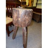 A 19th.C.RUSTIC CHOPPING BLOCK RAISED ON THREE SPLAYED LEGS. D.40xH.81cms.