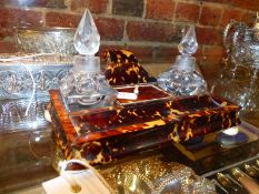 AN EARLY VICTORIAN TORTOISESHELL INKSTAND WITH TWO CRYSTAL WELLS AND IVORY BUN FEET. W.18cms.