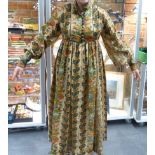 A GOOD VINTAGE LIBERTY'S PRINTED LINEN PLEATED AND BUTTONED DRESS IN THE EASTERN STYLE.