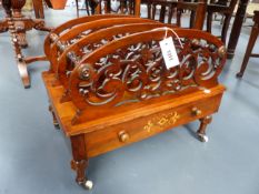 A VICTORIAN FOUR DIVISION CARVED AND INLAID WALNUT CANTERBURY WITH APRON DRAWER, RING TURNED LEGS