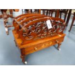 A VICTORIAN FOUR DIVISION CARVED AND INLAID WALNUT CANTERBURY WITH APRON DRAWER, RING TURNED LEGS