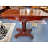 A VICTORIAN CARVED MAHOGANY GAMES TABLE WITH TAPERED PEDESTAL AND PLATFORM BASE ON BUN FEET. H.75