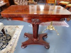 A VICTORIAN CARVED MAHOGANY GAMES TABLE WITH TAPERED PEDESTAL AND PLATFORM BASE ON BUN FEET. H.75