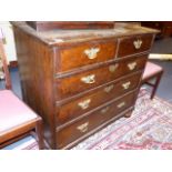 AN 18th.C.AND LATER WALNUT AND OAK CROSSBANDED CHEST OF TWO SHORT AND THREE LONG DRAWERS ON BUN