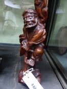 A CHINESE CARVED HARDWOOD STANDING FIGURE OF A SAGE. H.30cms.