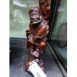 A CHINESE CARVED HARDWOOD STANDING FIGURE OF A SAGE. H.30cms.