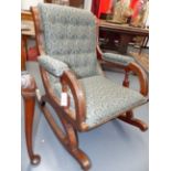 A CARVED MAHOGANY LATE VICTORIAN ROCKING CHAIR WITH REEDED FRAME AND SPINDLE SUPPORTS.