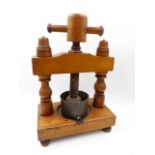 A TREEN ANTIQUE CONTINENTAL DUCK PATE PRESS. H.35cms.