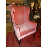 A 19th.C.HIGH WING BACK ARMCHAIR ON SQUARE TAPERED FORELEGS..