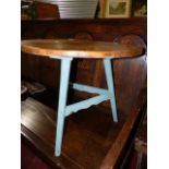 A COUNTRY PINE SMALL CRICKET TABLE WITH PAINTED BASE. D.60cms.