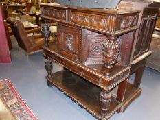 A 17th.C. AND LATER OAK DUODARN WITH CARVED CUPBOARD FLANKED BY COLUMNS OVER A POTBOARD BASE, W.