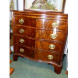 A CARVED MAHOGANY GEORGIAN STYLE SERPENTINE FORM SMALL CHEST WITH BRUSHING SLIDE, FOUR DRAWERS ON