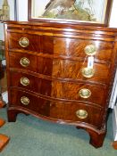 A CARVED MAHOGANY GEORGIAN STYLE SERPENTINE FORM SMALL CHEST WITH BRUSHING SLIDE, FOUR DRAWERS ON