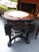 A CHINESE MARBLE TOP CARVED HARDWOOD STAND WITH SHAPED TOP AND PIERCED APRON. H.48 W.50cms.